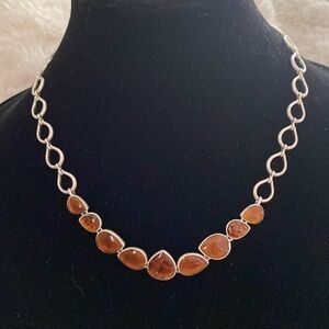 silver color necklace with imitation amber